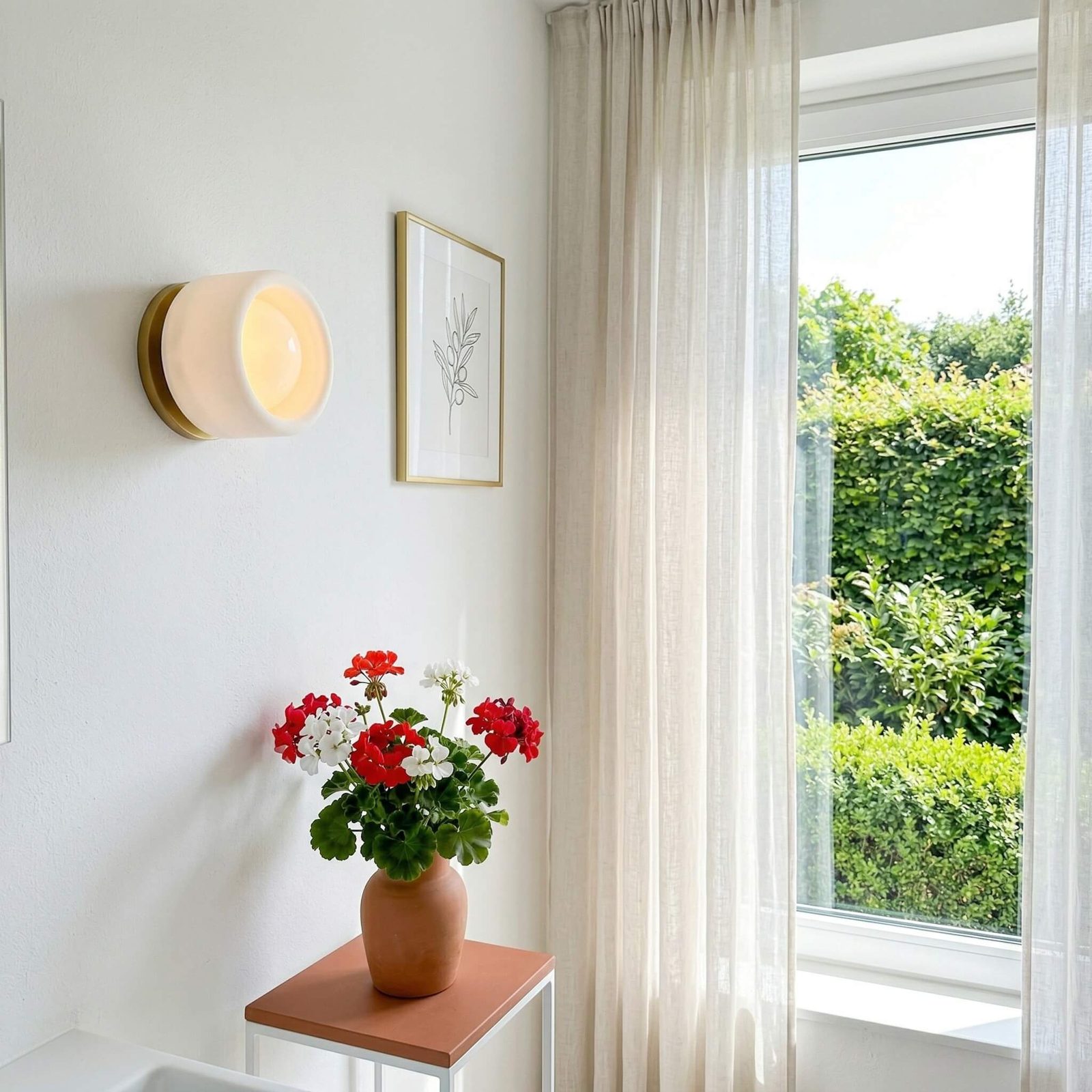 Cerova wall sconce beside a window