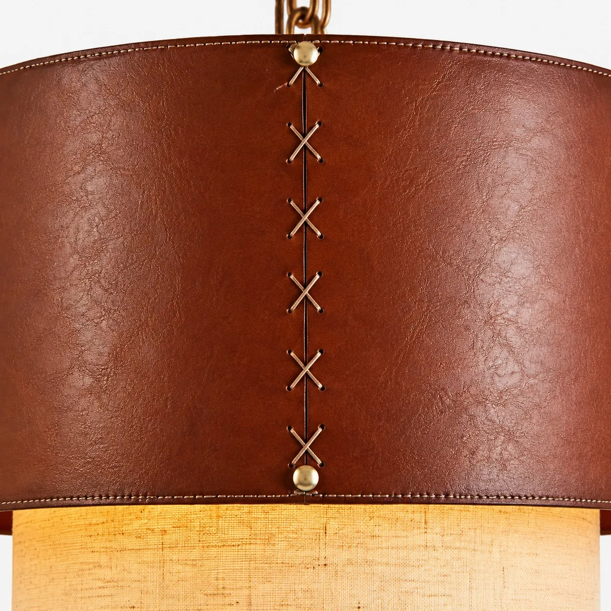 Lower edge detail of brown leather drum pendant shade