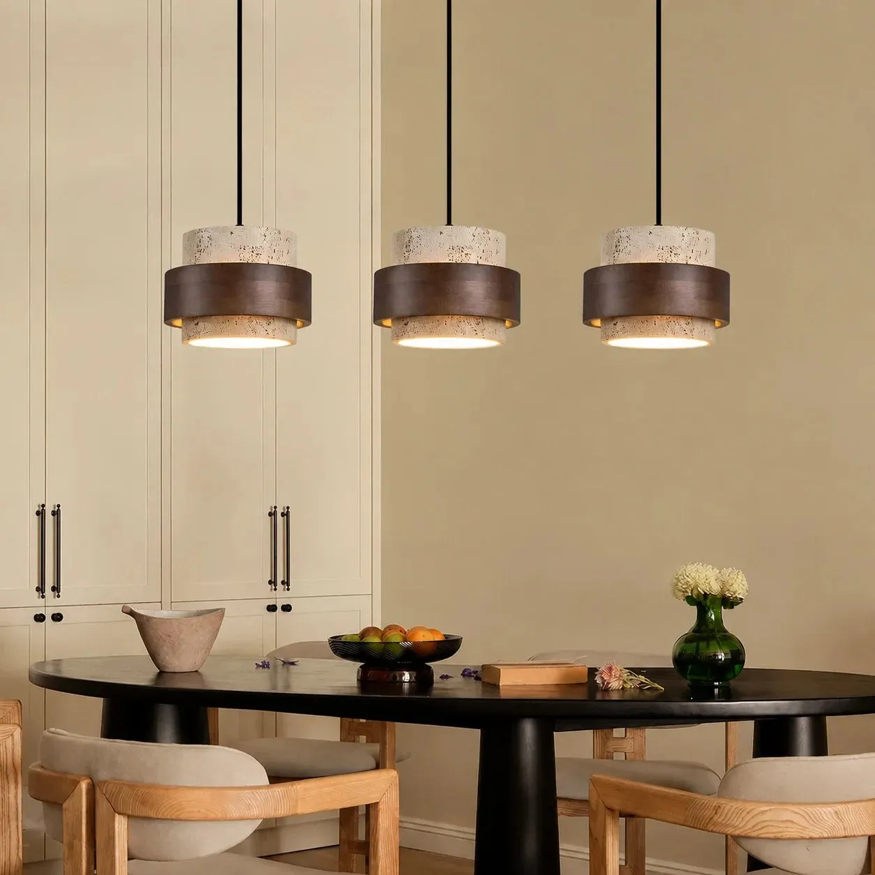 Three pendants over a dark dining table