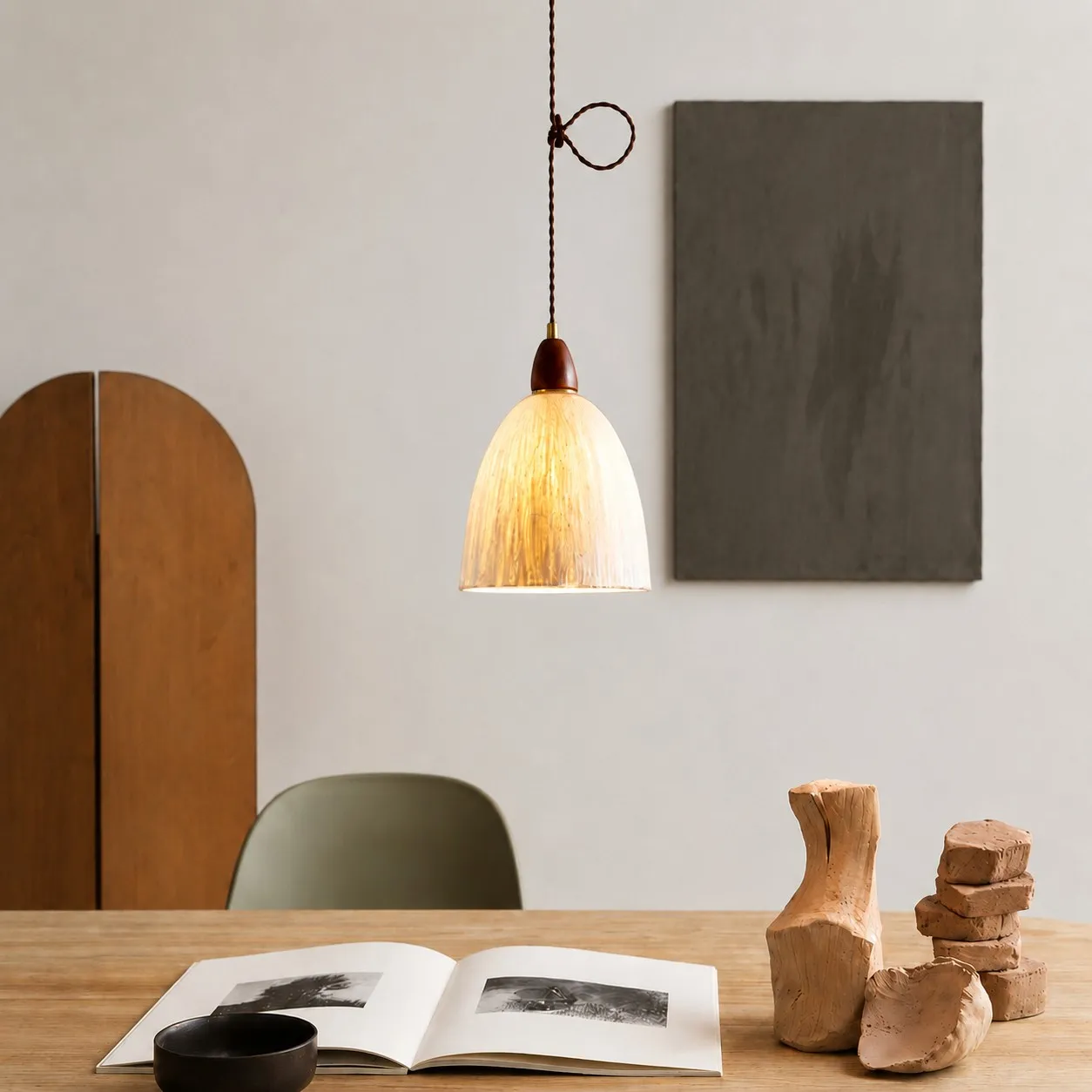 Tall rice paper pendant light over a table