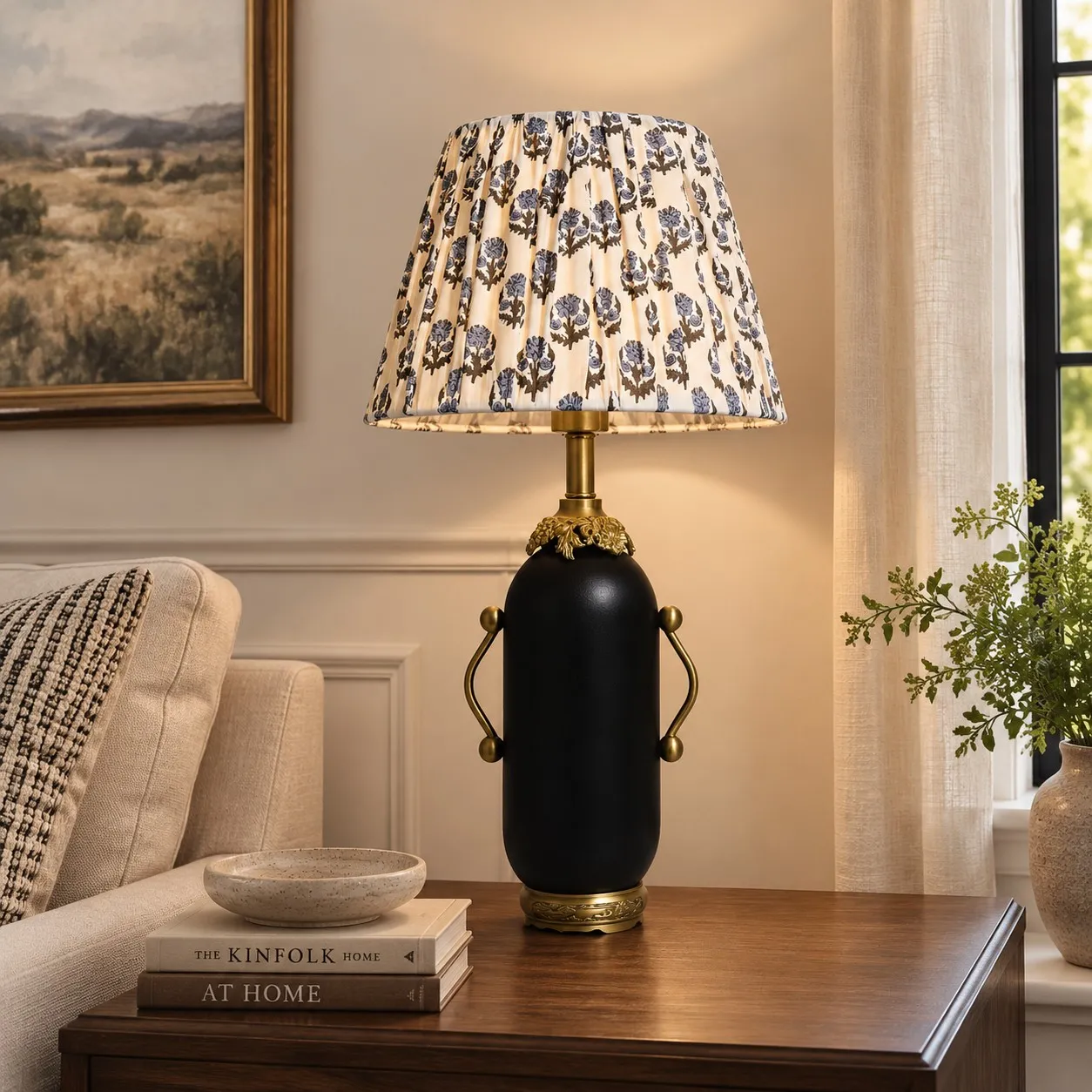 Matte black floral table lamp glowing on a dark side table